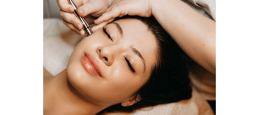 Woman getting microneedling treatment