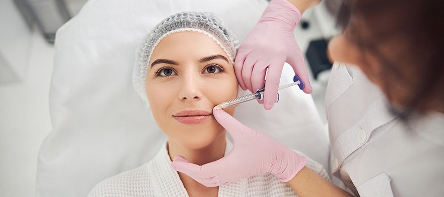 Woman getting lip augmentation injection